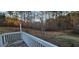 White deck with wooden floor and view of the backyard at 710 Seals Rd, Dallas, GA 30157