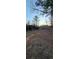 Rustic barn sits on a gravel area surrounded by trees at 710 Seals Rd, Dallas, GA 30157