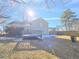 View of home's backyard with a wooden deck, lawn, and shade trees at 1330 Hillcrest Dr, Sugar Hill, GA 30518