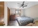 Bedroom featuring a ceiling fan, natural light from a window, and wood-look flooring at 1330 Hillcrest Dr, Sugar Hill, GA 30518