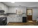 Bright kitchen with white cabinets, modern appliances, and a garden window over the sink at 1330 Hillcrest Dr, Sugar Hill, GA 30518