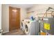 Laundry area with washer, dryer, and water heater at 1330 Hillcrest Dr, Sugar Hill, GA 30518