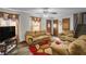 Cozy living room featuring plush furniture, decorative curtains, and wood-look flooring at 1330 Hillcrest Dr, Sugar Hill, GA 30518