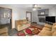 Living room with wood-look flooring, sofa, fireplace, and an open view to the kitchen at 1330 Hillcrest Dr, Sugar Hill, GA 30518