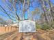 Outdoor shed with double doors in a spacious backyard with mature trees at 1330 Hillcrest Dr, Sugar Hill, GA 30518