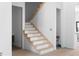 Modern wooden staircase with white risers at 223 Altoona Sw Pl, Atlanta, GA 30314