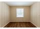 Simple bedroom with wood flooring and a window with blinds at 3936 Kirksford Dr, Decatur, GA 30035