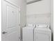 Laundry room with washer, dryer, and shelving at 400 W Peachtree Nw St # 2303, Atlanta, GA 30308