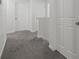 Clean hallway with grey carpeting and white doors at 860 N Bethany Rd, Mcdonough, GA 30252