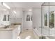 Bright bathroom with double sinks, bathtub and a glass shower enclosure with lots of natural light from windows at 1630 Bettis Tribble Gap Rd, Cumming, GA 30040