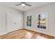 Bright bedroom featuring hardwood floors, two windows, a ceiling fan, and a double door closet at 1630 Bettis Tribble Gap Rd, Cumming, GA 30040