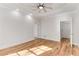 Spacious bedroom featuring hardwood floors, ceiling fan, tray ceiling, and multiple windows at 1630 Bettis Tribble Gap Rd, Cumming, GA 30040
