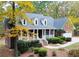 Charming brick home with a welcoming front porch, landscaped yard and beautiful autumn foliage at 1630 Bettis Tribble Gap Rd, Cumming, GA 30040