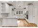 Elegant white kitchen with stainless steel appliances and a center island at 1630 Bettis Tribble Gap Rd, Cumming, GA 30040