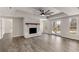 Large living room featuring a fireplace and doors to the outdoors at 1630 Bettis Tribble Gap Rd, Cumming, GA 30040