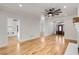 Open living space with a fireplace, hardwood floors, and views of the front door at 1630 Bettis Tribble Gap Rd, Cumming, GA 30040