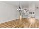 Open-concept living area with hardwood floors, leading to the kitchen at 1630 Bettis Tribble Gap Rd, Cumming, GA 30040