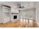 Bright living room features a white brick fireplace, built-in shelves, and French doors at 1630 Bettis Tribble Gap Rd, Cumming, GA 30040