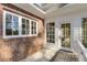 Back porch with access to backyard, brick accent and white trim at 1630 Bettis Tribble Gap Rd, Cumming, GA 30040