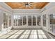 Bright sunroom featuring a wood ceiling, neutral tile floor, multiple windows and natural light at 1630 Bettis Tribble Gap Rd, Cumming, GA 30040