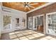Spacious sunroom with brick accent wall, tile floor and access to the home and outdoor porch at 1630 Bettis Tribble Gap Rd, Cumming, GA 30040