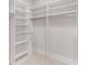 Spacious walk-in closet with custom shelves, drawers, and ample storage for clothes, shoes and accessories at 1630 Bettis Tribble Gap Rd, Cumming, GA 30040