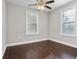 Bright bedroom featuring hardwood floors, natural light from two windows, and a ceiling fan at 2183 Pansy Nw St, Atlanta, GA 30314