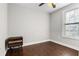 A cozy bedroom featuring hardwood floors and a nightstand beside a window with streaming sunlight at 2183 Pansy Nw St, Atlanta, GA 30314