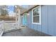 The house has a cozy porch, classic white railing, and a bright blue door at 2183 Pansy Nw St, Atlanta, GA 30314