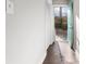 Hallway with aqua door leads to a fenced backyard; features hardwood floors and a closet at 2183 Pansy Nw St, Atlanta, GA 30314