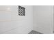 Close-up of a modern tiled shower with a decorative black-and-white niche and matching tile floor at 2183 Pansy Nw St, Atlanta, GA 30314