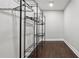 Bright walk-in closet features dark hardwood floors and adjustable metal shelving for optimal storage at 2183 Pansy Nw St, Atlanta, GA 30314