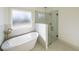 Bathroom with a freestanding tub and a walk-in shower at 5470 Crow Dr, Cumming, GA 30041