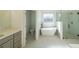 Elegant bathroom with soaking tub, walk-in shower, and modern vanity at 5470 Crow Dr, Cumming, GA 30041