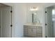 Vanity with quartz countertop and gold hardware in a bright bathroom at 5470 Crow Dr, Cumming, GA 30041