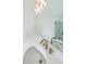 Vanity with double sinks and a modern light fixture at 5470 Crow Dr, Cumming, GA 30041