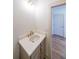 Modern bathroom with a vanity, sink, and a view into another room at 5470 Crow Dr, Cumming, GA 30041