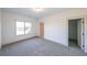 Bright bedroom with grey carpet and large window at 5470 Crow Dr, Cumming, GA 30041