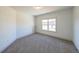 Bright bedroom with grey carpet and window at 5470 Crow Dr, Cumming, GA 30041
