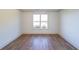 Simple bedroom with hardwood floors and a large window at 5470 Crow Dr, Cumming, GA 30041