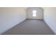 Spacious bedroom with grey carpet and a large window at 5470 Crow Dr, Cumming, GA 30041