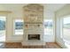 Stone fireplace is a focal point in this bright and airy living room at 5470 Crow Dr, Cumming, GA 30041