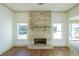 Stone fireplace in living room with hardwood floors at 5470 Crow Dr, Cumming, GA 30041