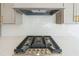 Modern kitchen features stainless steel appliances and white herringbone backsplash at 5470 Crow Dr, Cumming, GA 30041