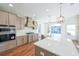 Modern kitchen with large island, stainless steel appliances, and hardwood floors at 5470 Crow Dr, Cumming, GA 30041