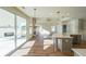 Open kitchen with island, white quartz countertops, and gray cabinets at 5470 Crow Dr, Cumming, GA 30041
