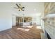 Sun-drenched living area features hardwood floors and a stone fireplace at 5470 Crow Dr, Cumming, GA 30041