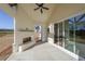 Covered patio with fireplace, ceiling fan and sliding glass doors at 5470 Crow Dr, Cumming, GA 30041