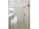 Large walk-in shower with marble tile and glass enclosure at 5470 Crow Dr, Cumming, GA 30041