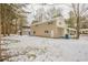 View of the back of house and snowy yard at 6695 Buckhurst Trl, Atlanta, GA 30349